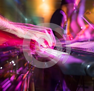 Musician plays keyboards in a rock band