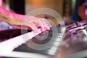 Musician plays keyboards in a rock band