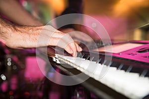 Musician plays keyboards in a rock band