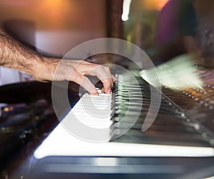 Musician plays keyboards in a rock band