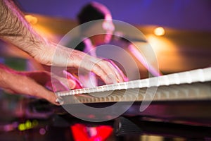 Musician plays keyboards in a rock band