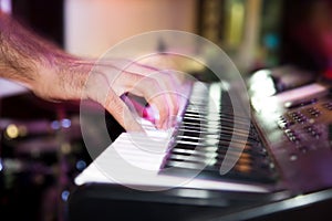 Musician plays keyboards in a rock band