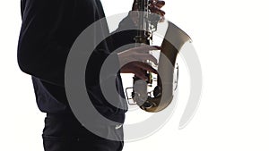 Musician plays an old saxophone. Closeup on white background