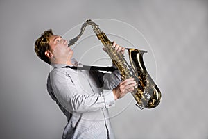 Musician plays the saxophone.