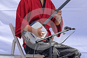 The musician plays the shamisen