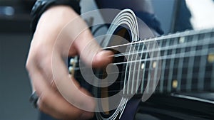 Musician Plays Strings With His Fingers On An Guitar.