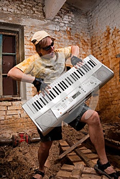 Musician plays a synthesizer