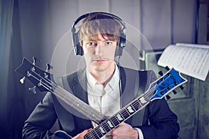 Musician portrait in studio with two guitars