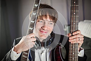 Musician portrait in studio with two guitars