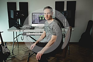 Musician and producer poses happy at his home studio