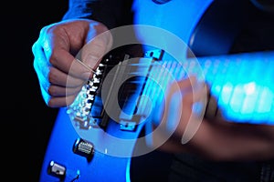 Musician rock guitarist playing a blue guitar