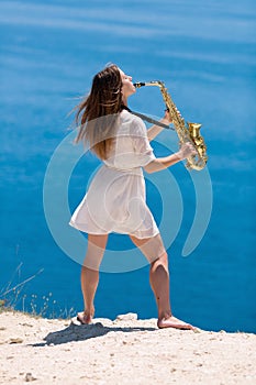 Musician on rocky seashore
