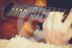 A musician`s hand  and an old guitar