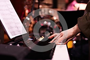 Musician's Hands on Piano Keys at Concert