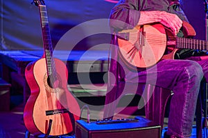 Musician seen on stage with guitars