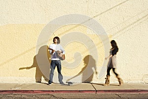 Musician on Sidewalk and Woman Pedestrian