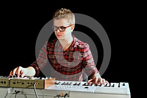Musician sits and plays electric organ