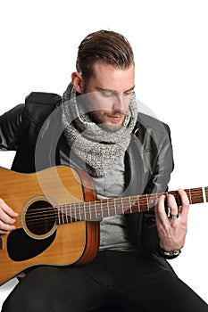 Musician sitting down with guitar