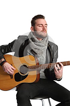 Musician sitting down with guitar