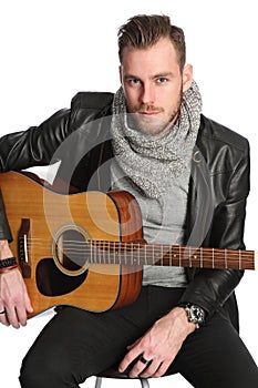 Musician sitting down with guitar