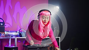 Musician standing at dj table mixing sound