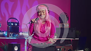 Musician standing at dj table performing electronic song