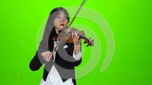 Musician standing and playing the violin. Green screen