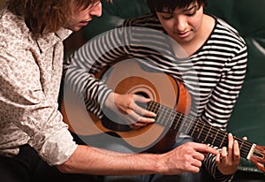 Musician Teaches Female Student To Play the Guita