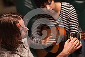 Musician Teaches Female Student To Play Guitar