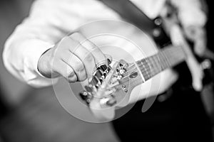 A musician tunes a guitar