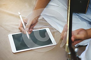 Musicians play guitar and compose songs using the tablet.