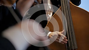 Musicians playing cello and violin. Close-up of hands and tools.