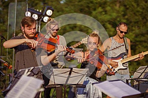 Musicians playing classic instrumental music at outdoor concert