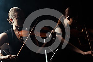 Musicians playing classical music on violins