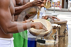 Musicians playing typical instruments of African origin used in capoeira and other Brazilian cultural events photo