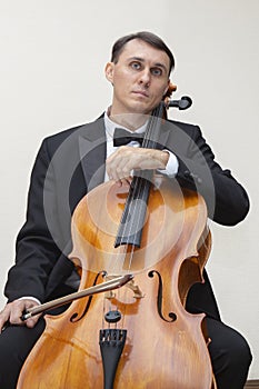 Musicians of the symphony orchestra. Cellist in concert costume