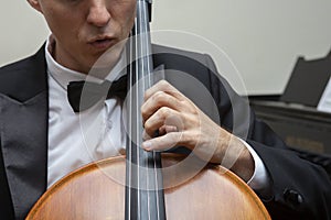 Musicians of the symphony orchestra. Cellist in concert costume