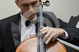 Musicians of the symphony orchestra. Cellist in concert costume