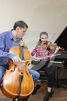 Musicians of the symphony orchestra. Young violinist and cellist in concert costumes