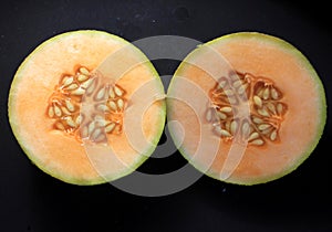 Musk melon summer fresh fruit on black background