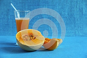 Muskmelon fruit and juice isolated on light blue background photo