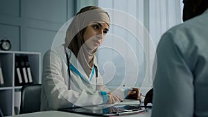 Muslim arabian woman young female doctor therapist write medical prescription recipe for sick patient writing notes