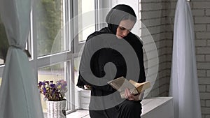 Muslim arabic female reading book at home