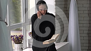 Muslim arabic female reading book at home