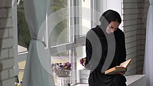 Muslim arabic female reading book at home