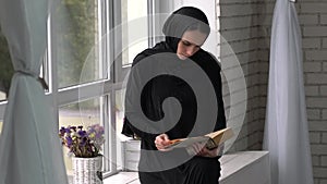 Muslim arabic female reading book at home.Middle east