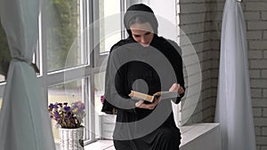 Muslim arabic female reading book at home.Middle east