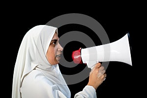 Muslim Arabic woman with hijab shouting through megaphone calling for Hajj photo