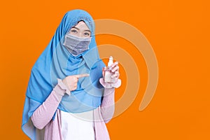 Muslim Asian woman with traditional dress wearing medical face mask