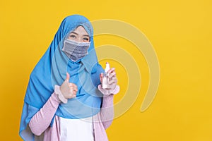 Muslim Asian woman with traditional dress wearing medical face mask